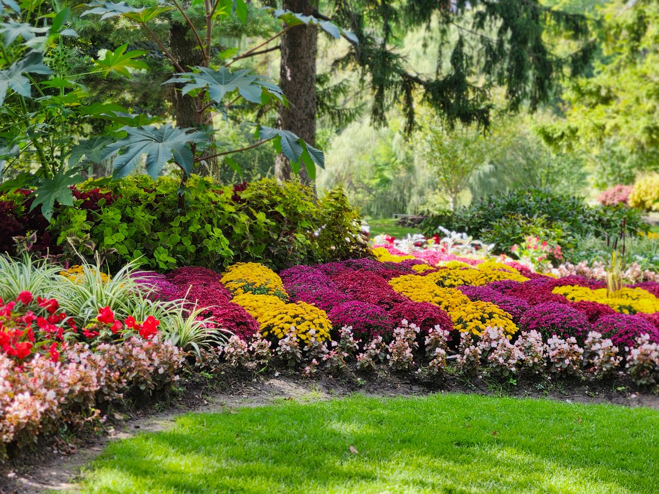About Colorful garden with lush foliage and blooming flowers in a Toronto park.